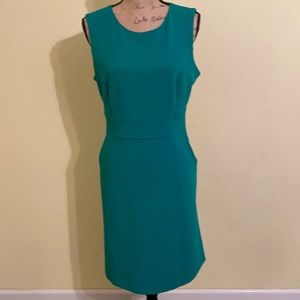 Green Calvin Klein shift dress with pockets.
